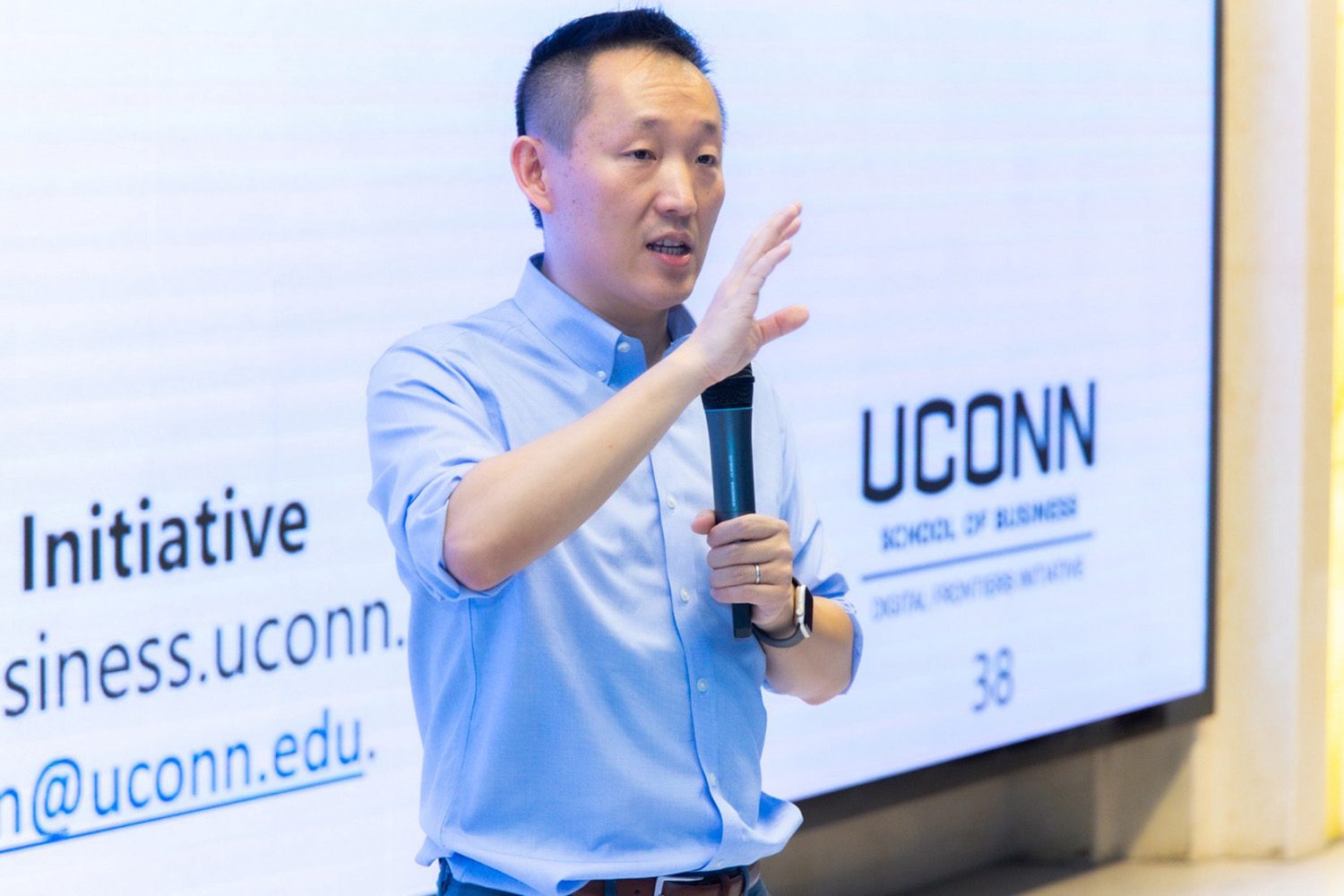 Wei Chen Early Career Award OPIM Professor Wei Chen speaking into a microphone.